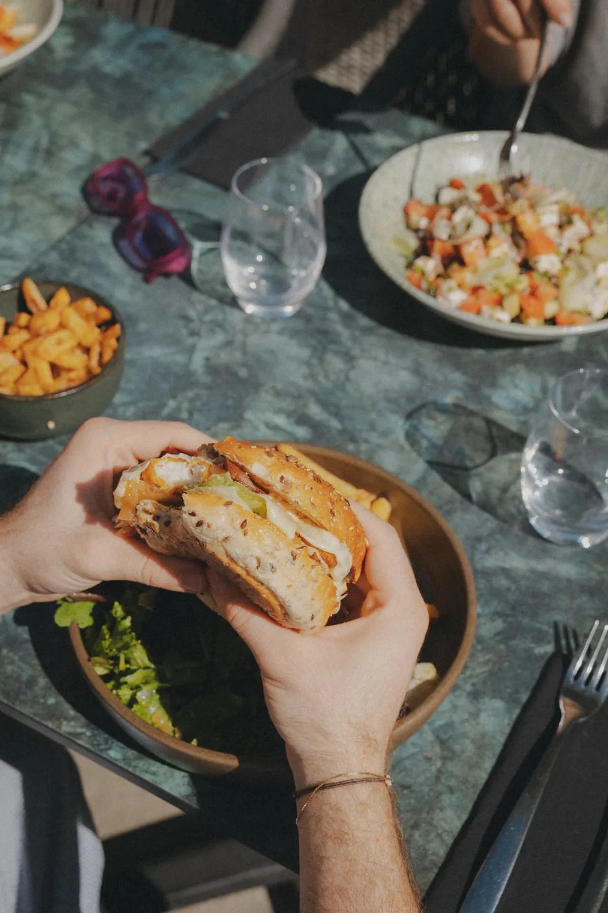 Burger and fries served on the terrace at The Cannes Motel